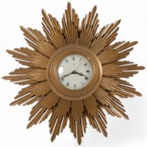 A mid-20th century Metamec electric giltwood-cased sunburst wall clock, dial Roman numerals,