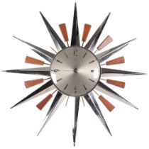 A Metamec starburst wall clock, W60cm There are 3 of the wood sections missing, with quartz