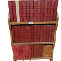 A pine bookcase containing a collection of Dennis Wheatley books, distributed by Heron books,
