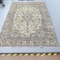 A cream-ground Kirman carpet. 284x188cm.