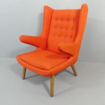 A mid-century Papa Bear style wing chair in the manner of Hans Wegner. Split to front of one leg,