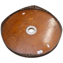 An Edwardian oak tea tray, with a pierced silver plate and copper shaped gallery, diameter 47.5cm