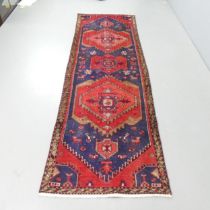 A red and blue-ground Persian runner. 264x81cm.