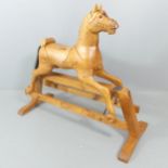 A vintage pine rocking horse on stand. 133x113x54cm Some damage to main, probably due to a flaw in