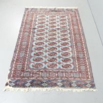 A red-ground Afghan rug. 188x125cm. Some moth damage. Sold as seen.