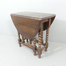 An oak oval gate-leg drop-leaf table. 74x72x37cm (opening to 108cm).