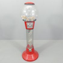 A vintage coin-in-slot gumball dispensing machine. Height 125cm. No key.