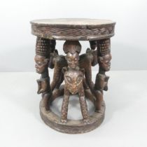 A Cameroon Bamenda stained and carved wood centre table. 65x74x58cm.