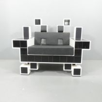 A hand made Space Invader lounge chair, fitted with concealed drawers to arms, and with speakers (