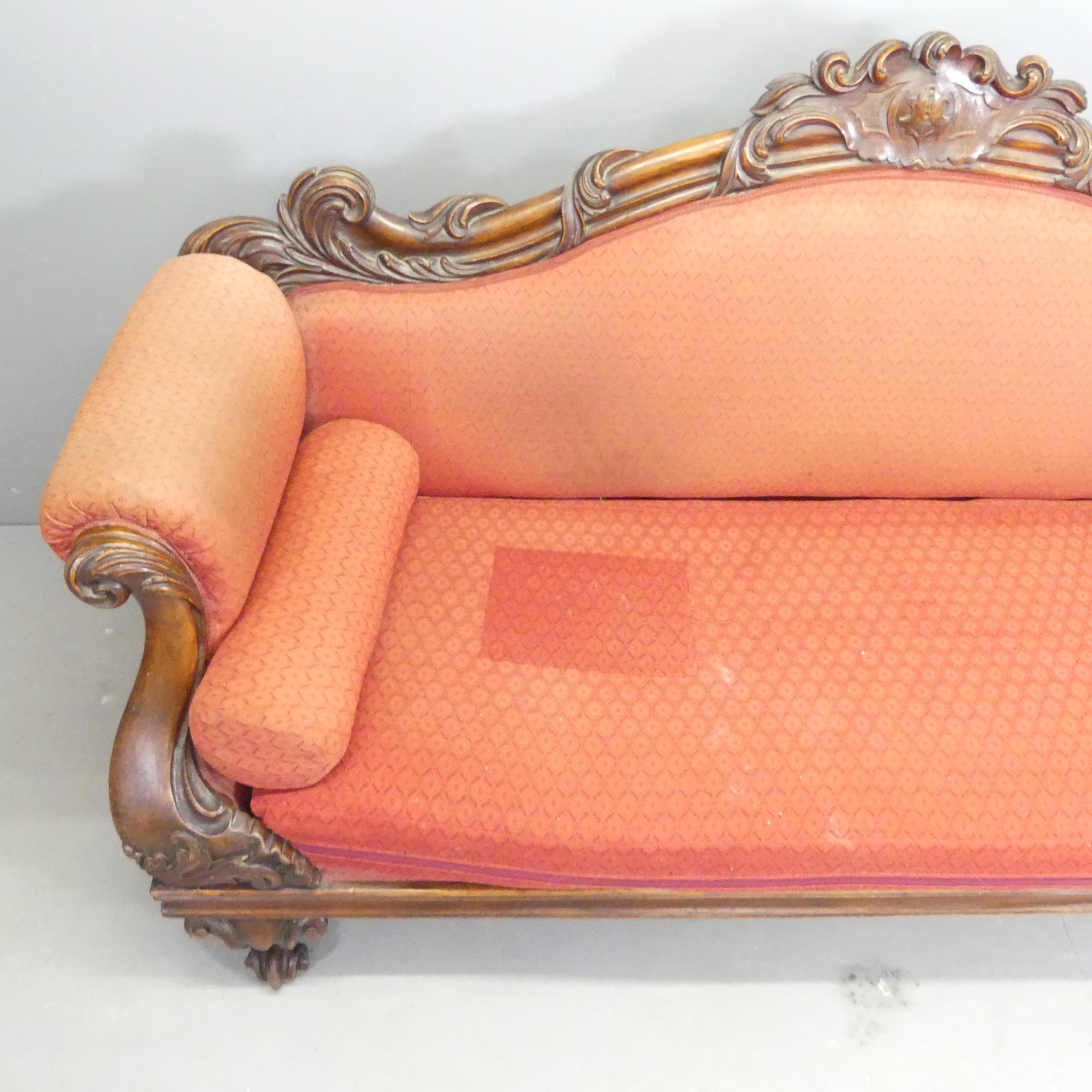 A Victorian mahogany and upholstered sofa, with carved acanthus leaf and lion paw decoration. - Image 2 of 2
