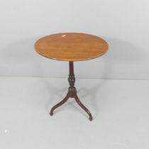 A 19th century mahogany oval top wine table in tripod base. 50x70x38cm.