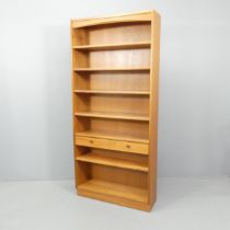 PARKER-KNOLL - A mid-century teak open bookcase, with maker's label. 87x193x27cm.