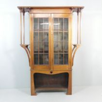 An Arts & Crafts / Art Nouveau display bookcase cabinet in the manner of Liberty & Co. 140x194x36cm.