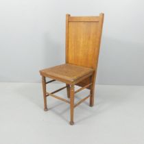 An Edwardian oak taylor's shop trouser press chair. With maker's label. Label is indistinct.