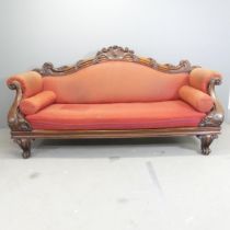 A Victorian mahogany and upholstered sofa, with carved acanthus leaf and lion paw decoration.