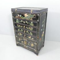 A Chinese black lacquered tall-boy / dressing chest, with lifting lid, four drawers and cupboards