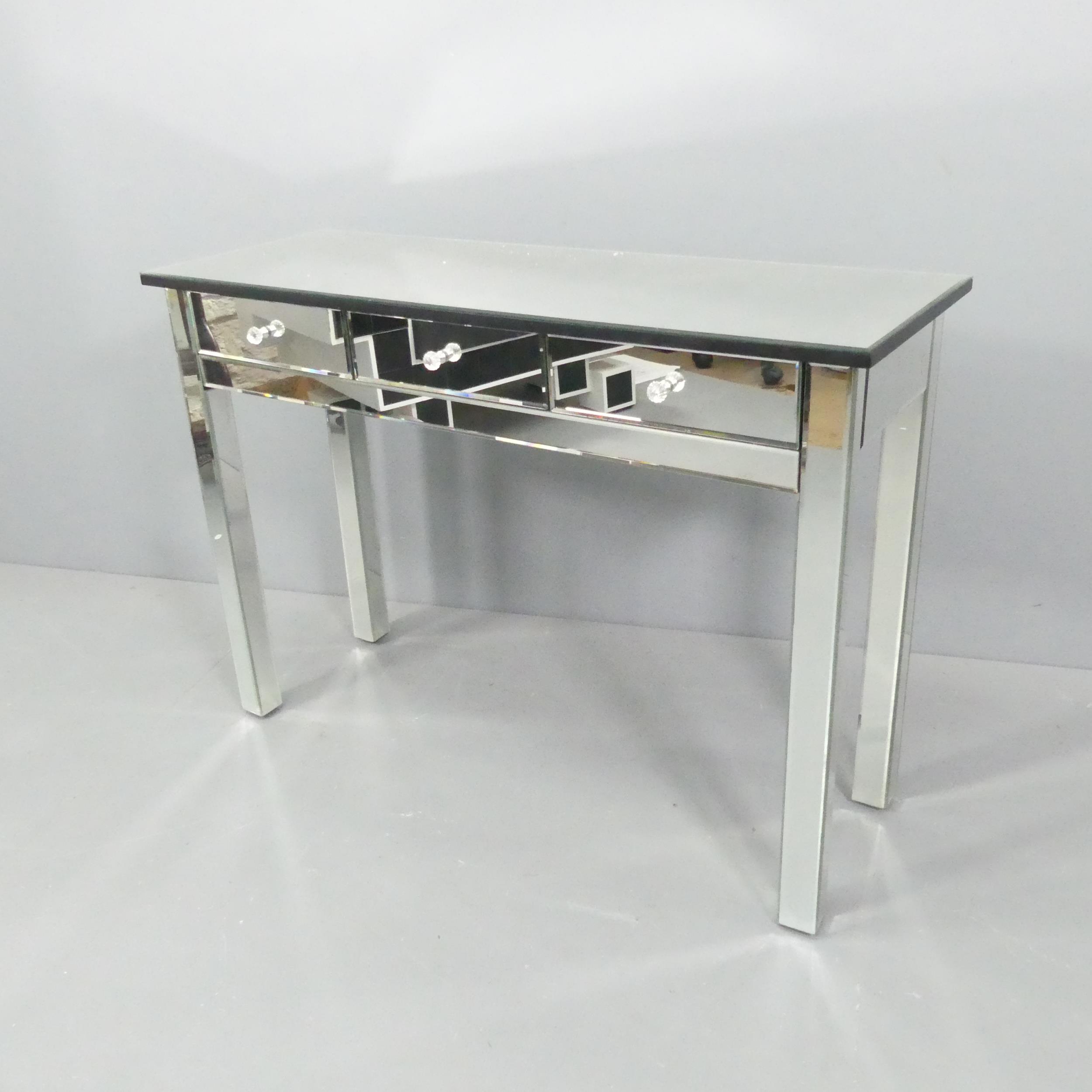 A contemporary mirrored console table with three drawers. 110x78x40cm.