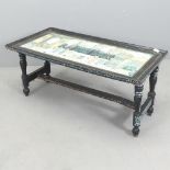An Indian black-lacquered rectangular coffee table with hand painted decoration, and raised on