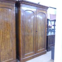 A Victorian mahogany wardrobe, with two arch labelled doors, and drawer and slide fitted interior.