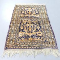 A cream and blue-ground Turkish rug. 136x88cm.