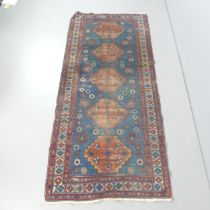 A blue-ground Caucasian rug. 244x107cm.