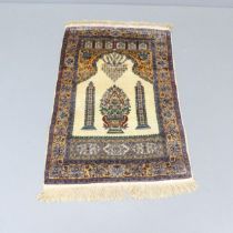 A silk cream-ground Persian prayer mat. 125x80cm.