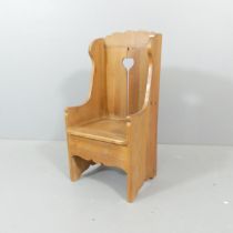 A child size pine lambing chair with cutout decoration. Overall 36x75x34cm, seat 33x29x29cm.