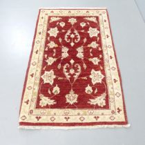 A red-ground Turkish rug. 150x92cm.