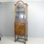 A 19th century two-section walnut veneered bookcase, with arch top, lattice glazed door, single