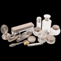 A group of various silver-topped rouge pots, scent bottles, nail buffer, etc