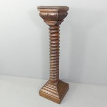 A large and impressive French elm spiral turned column, with carved decoration and stepped