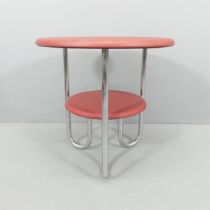 A mid-century Bauhaus two-tier table, with faux-leather tops and tubular metal frame. In the