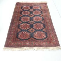 A red-ground Afghan rug. 195x128cm.