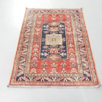 A red and cream-ground Persian mat. 108x79cm.