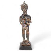 Baule carved wood Tribal figure with beadwork mounts, Ivory Coast, height 25cm