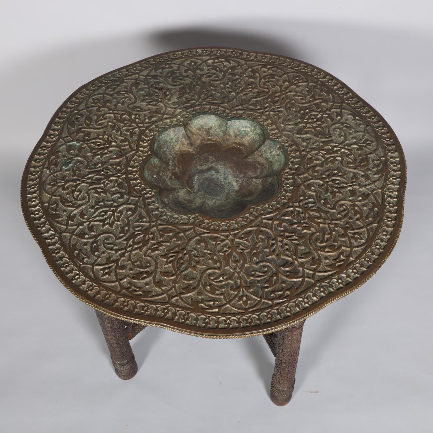 A Middle Eastern bras tray-top table, late 19th/early 20th century, with relief embossed top on - Image 2 of 3