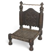 A 19th century Indian wedding chair, with carved back and woven leather seat, height 77cm