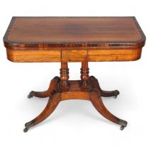 Regency rosewood and coromandel fold over card table, on sabre leg base, width 92cm