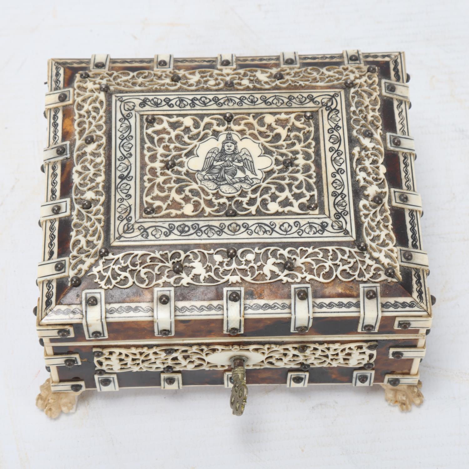 An Indian tortoiseshell and ivory box, circa 1900, with pierced ivory mounts and carved feet, - Image 2 of 3