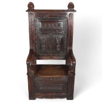 Antique carved and panelled oak hall settle, with rising seat, width 76cm, height 152cm