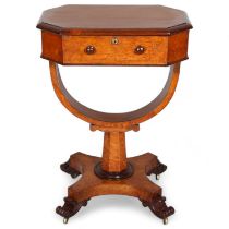 A 19th century maple sewing table with rising top, yoke-shaped stretcher and carved feet, 52cm x