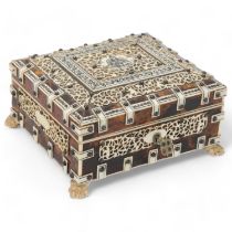 An Indian tortoiseshell and ivory box, circa 1900, with pierced ivory mounts and carved feet,