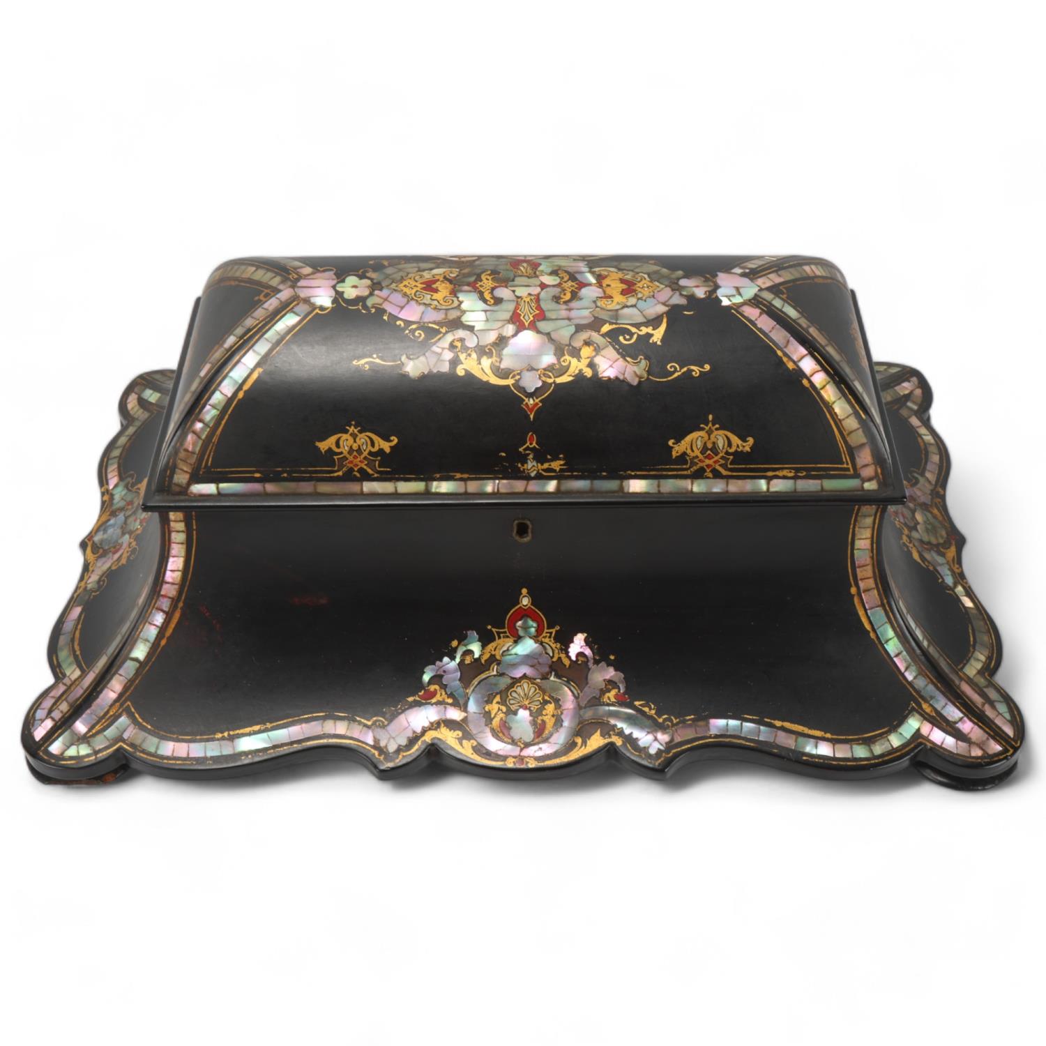 A 19th century papier mache tea caddy, inlaid mother-of-pearl and gilded decoration, with inner lids