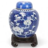 A Chinese blue and white porcelain ginger jar and cover, on original carved wood stand, overall