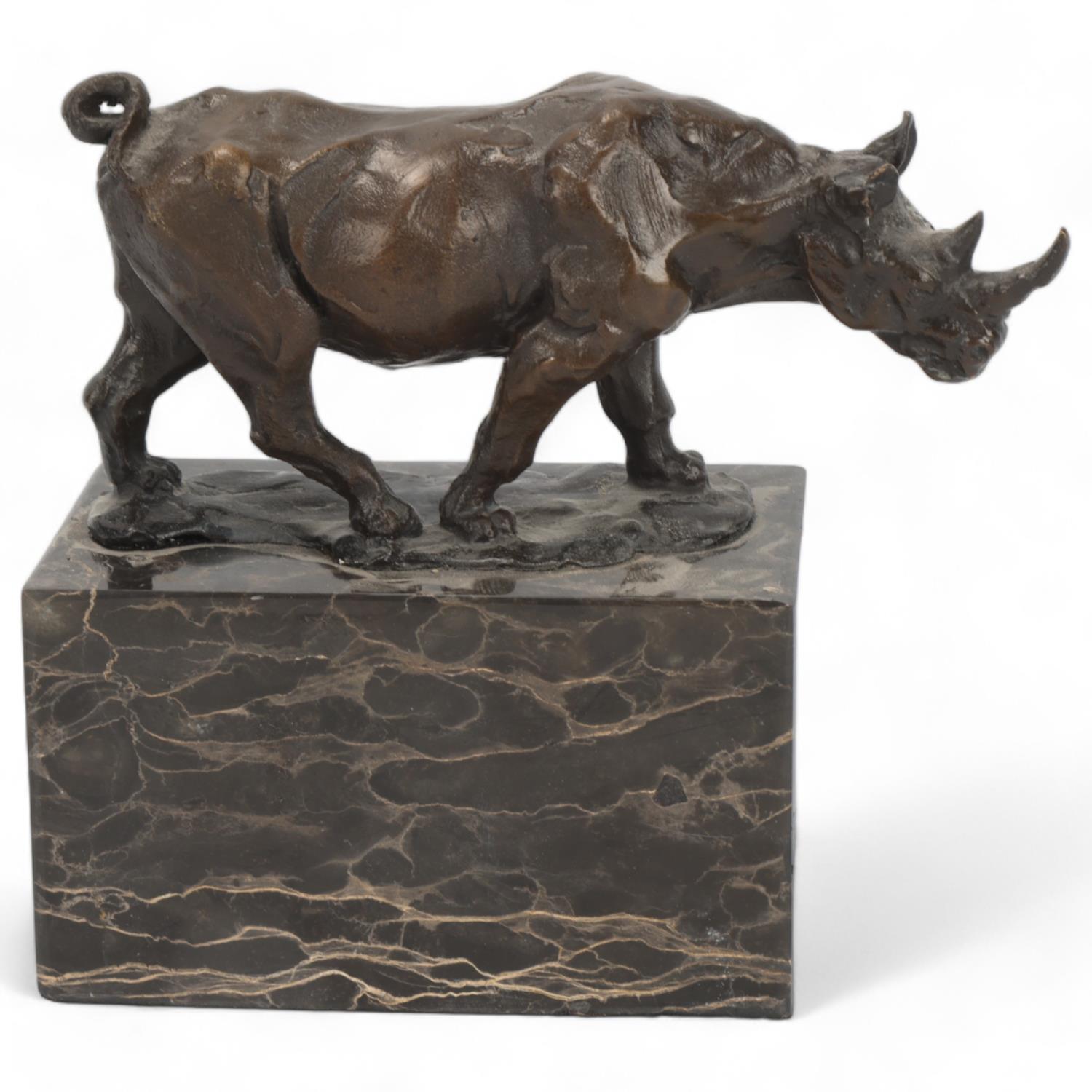 Contemporary bronze rhino sculpture, on marble block base, indistinctly signed, rhino length 15.5cm,