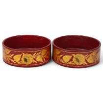 Pair of Regency red lacquer and hand painted gilt decorated papier mache wine bottle coasters, circa