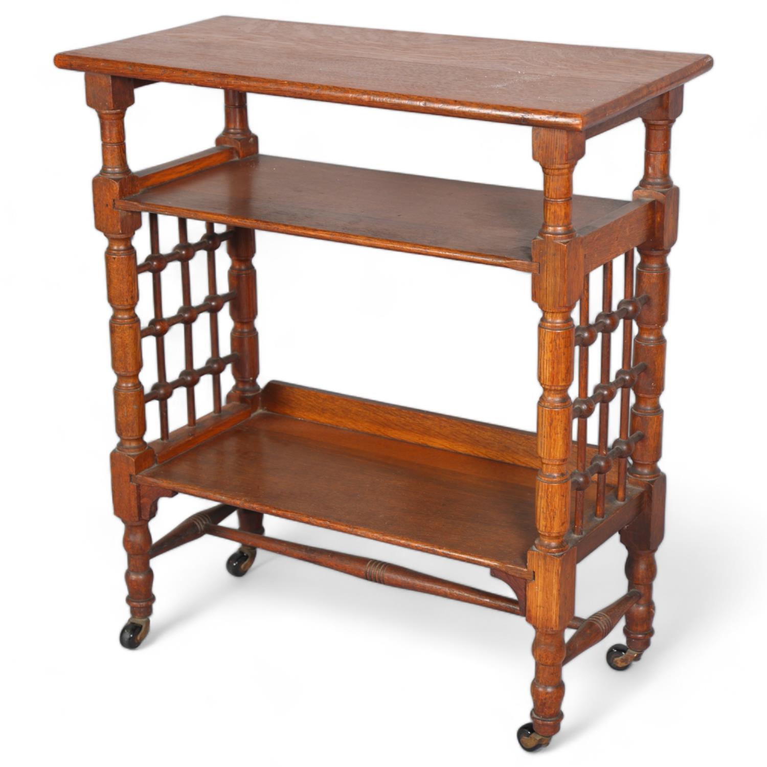 Leonard Wyburd for Liberty & Co, oak 3-tier library table, with bobbin spindle side panels, and