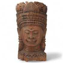 A large Burmese relief carved wood mask wall carving, height 67cm