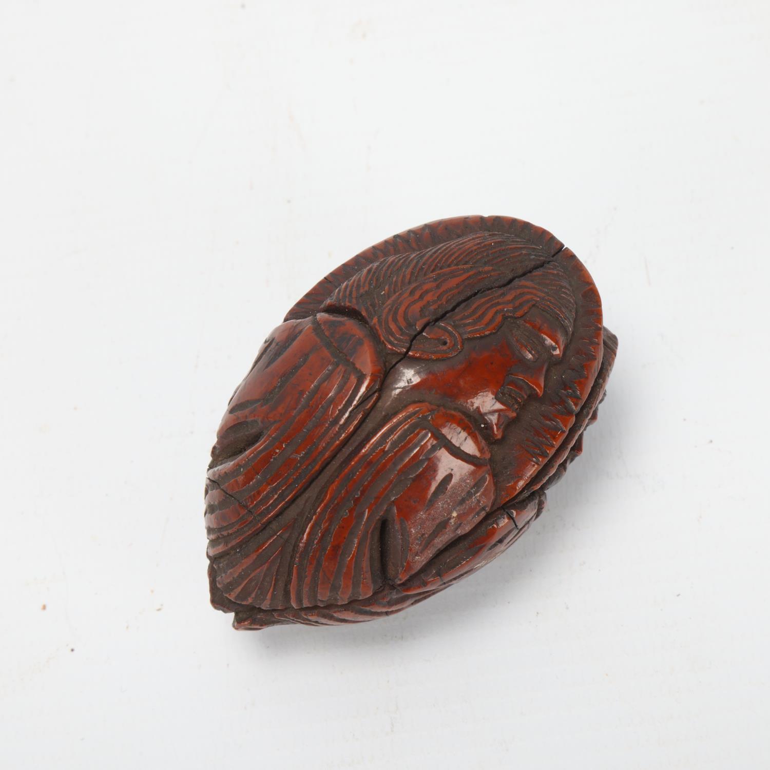 19th century coquilla nut, relief carved all round with portraits of men, length 6.5cm Several age- - Image 2 of 3