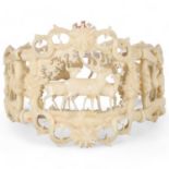 A 19th century carved and pierced bone bracelet, depicting stags in woodland, central panel height